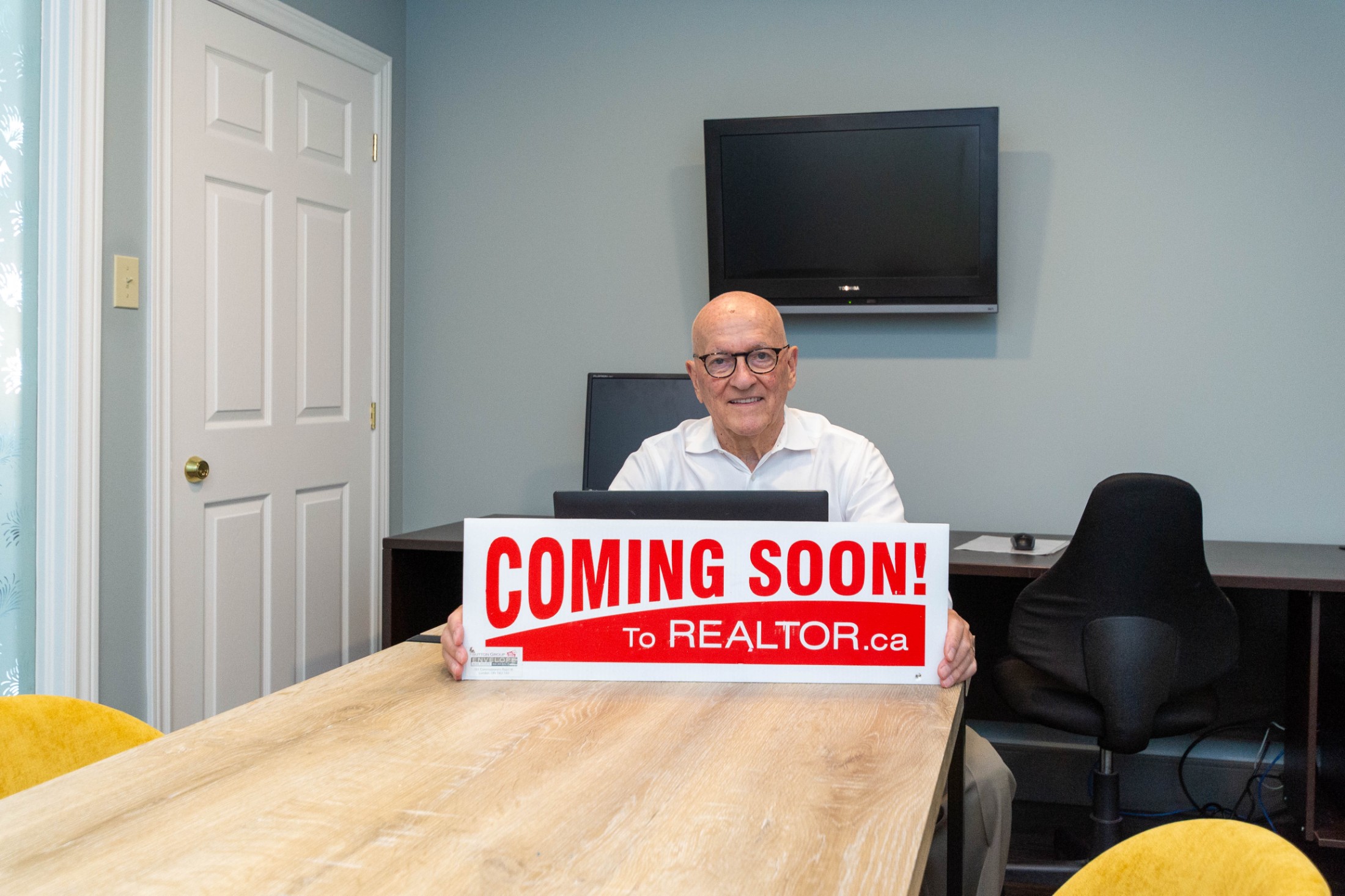 Ty Lacroix holding a coming soon sign